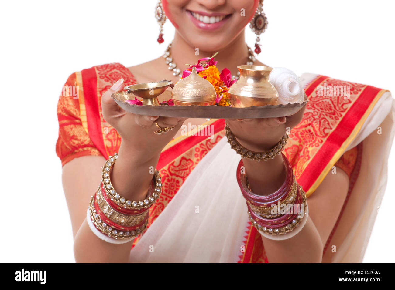 Close-up of Bengali woman's hands holding puja thali Stock Photo