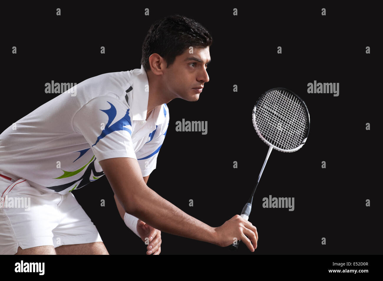 Young male player with racket playing badminton isolated over black  background Stock Photo - Alamy