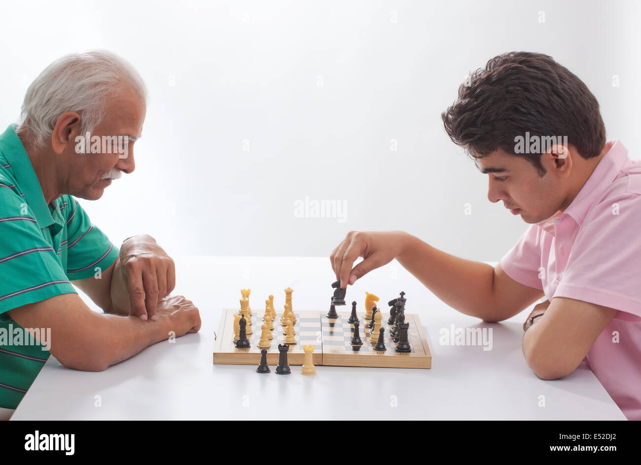 Grandfather and grandson playing chess Stock Photo