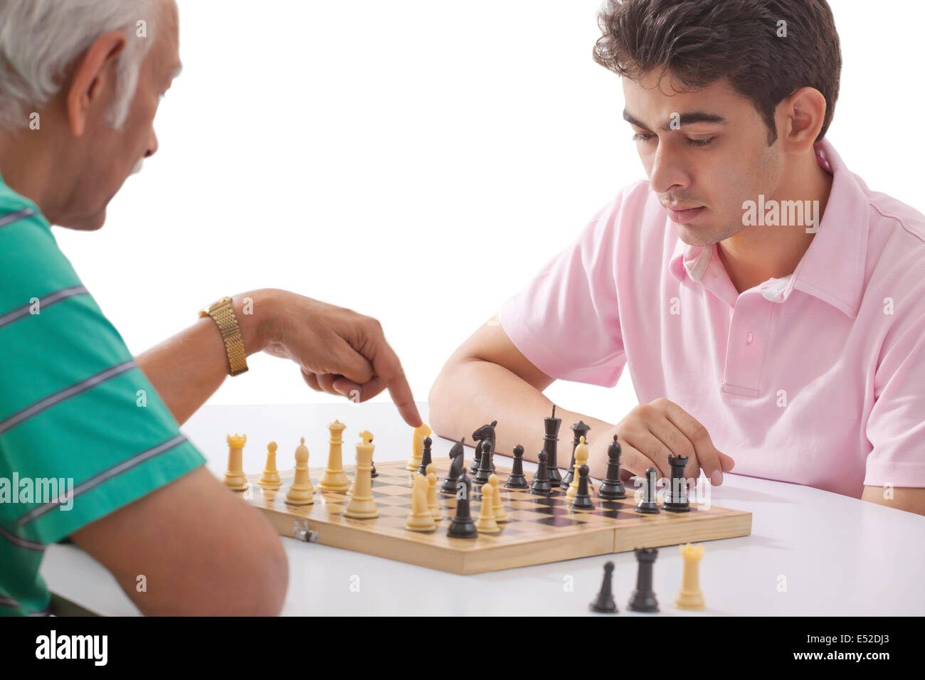 Grandfather and grandson playing chess Stock Photo