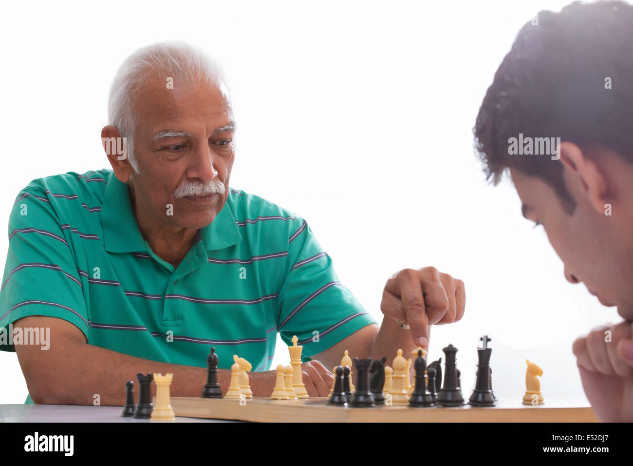 Grandfather and grandson playing chess Stock Photo