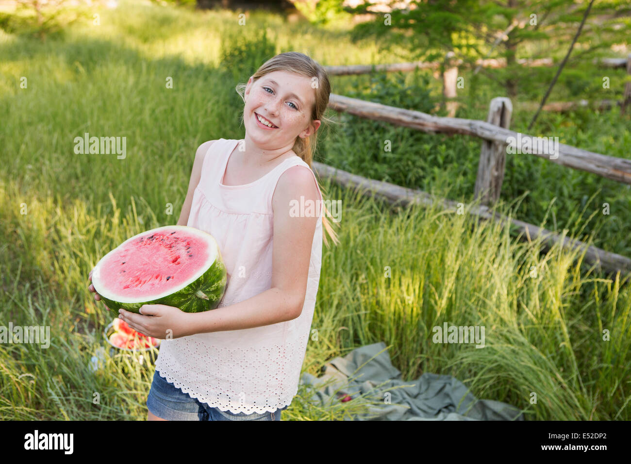 A child holding half a fresh water melon. Stock Photo