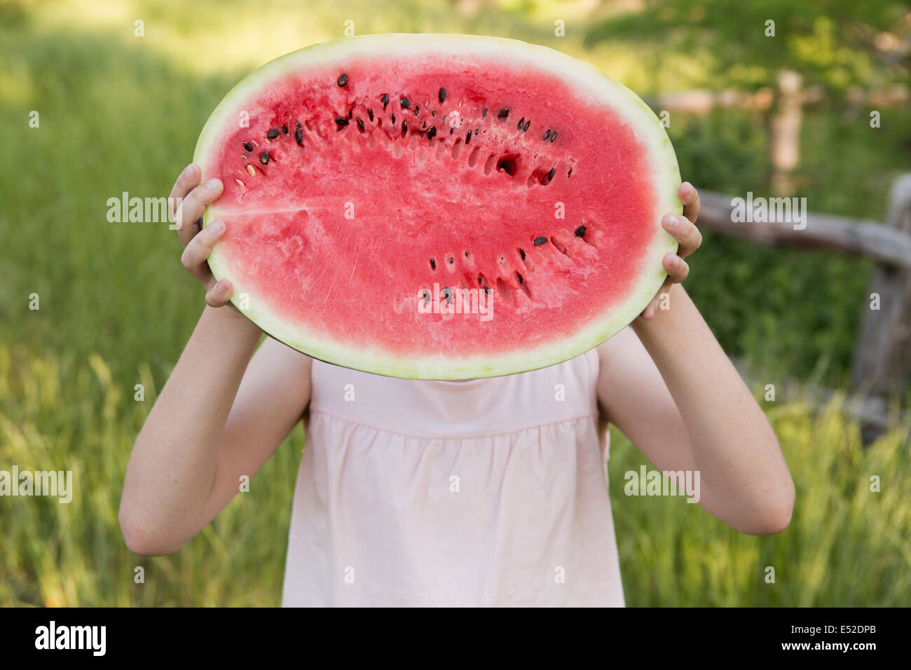 A child holding half a fresh water melon. Stock Photo