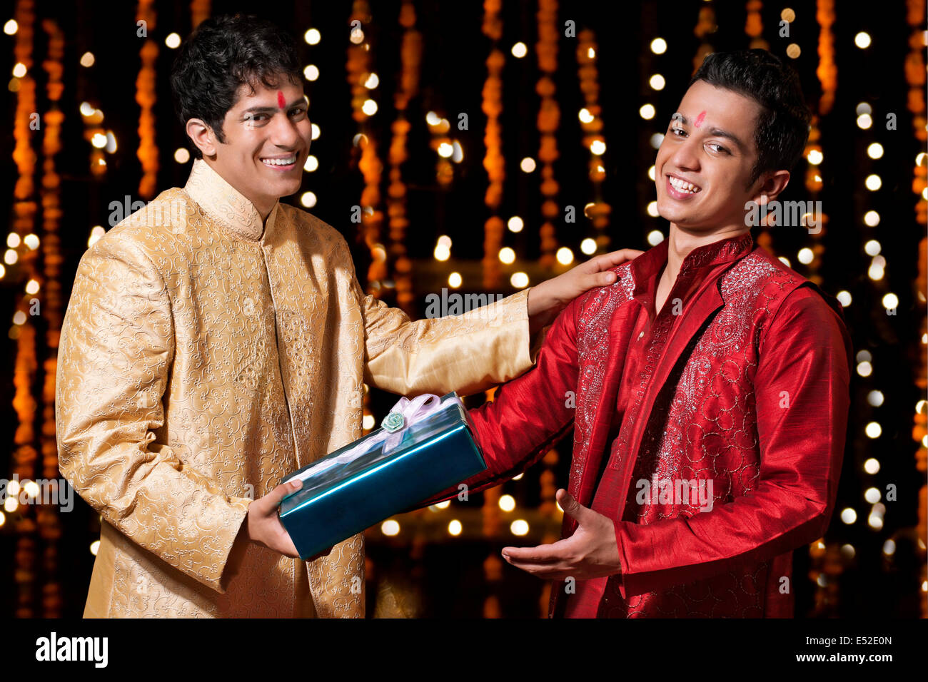 Portrait of two men exchanging gifts Stock Photo