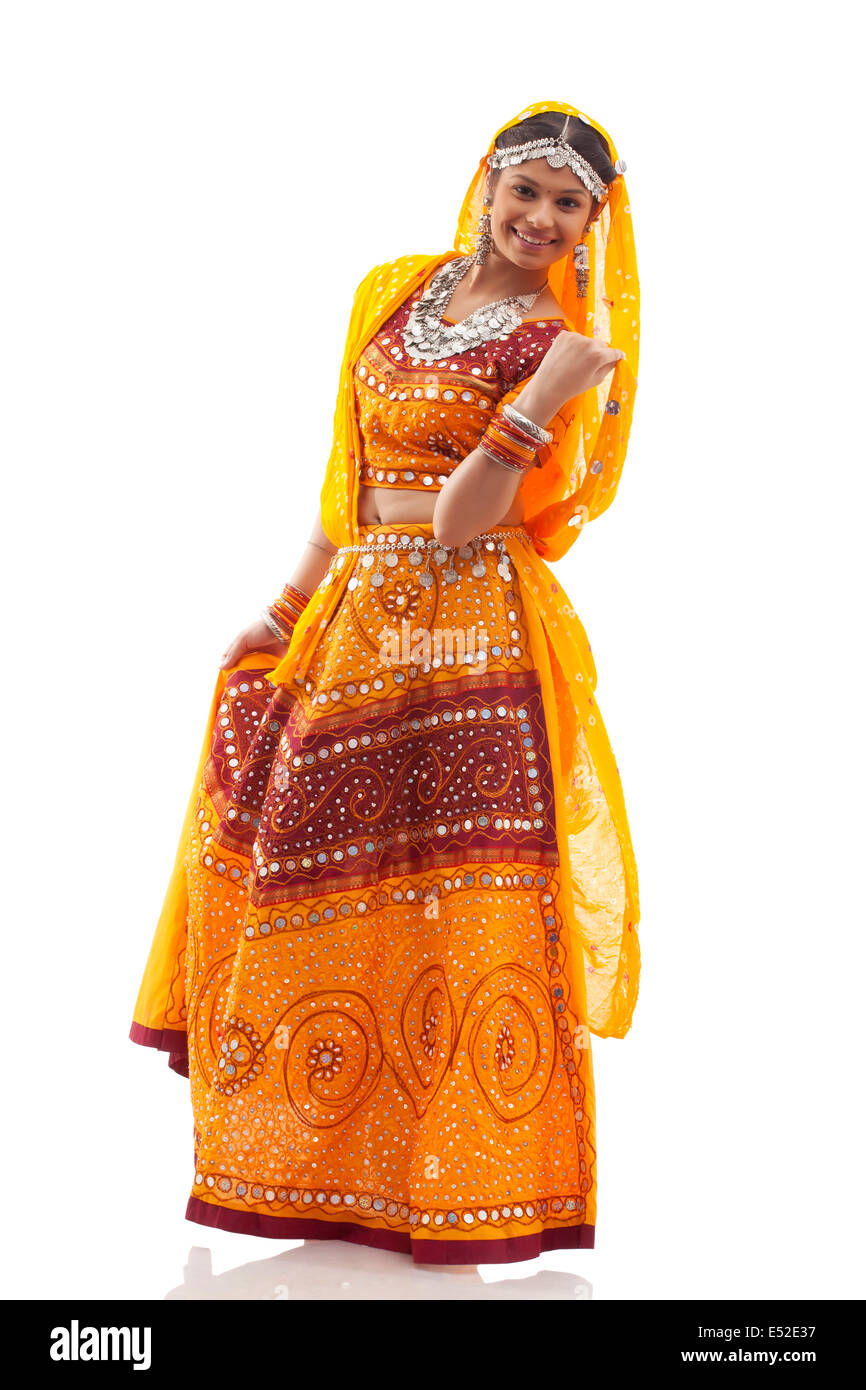 Full length portrait of happy young woman wearing chaniya choli isolated over white background Stock Photo