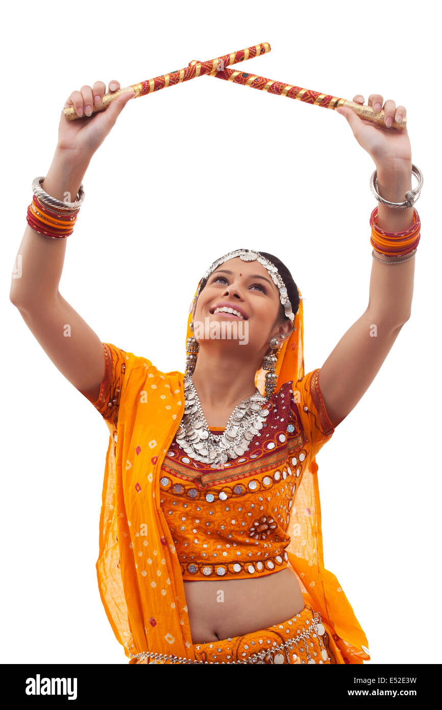 Gujarati woman dancing with dandiya sticks Stock Photo | Adobe Stock
