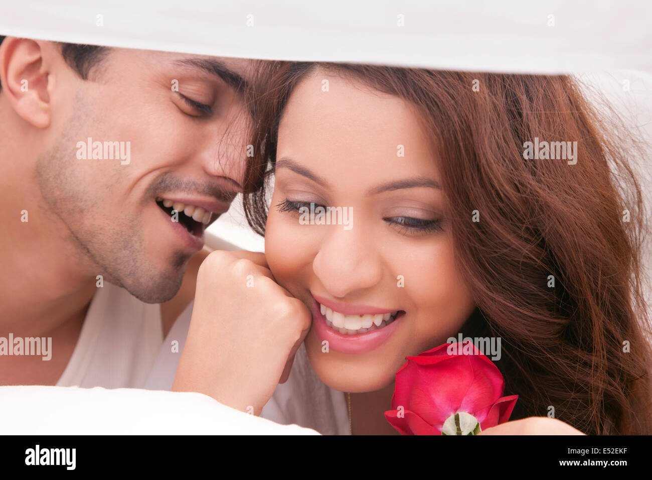 Couple romancing in bed Stock Photo - Alamy
