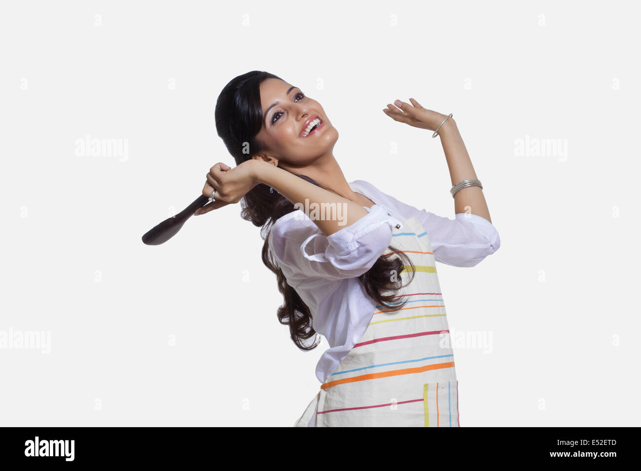Woman with a cooking utensil rejoicing Stock Photo