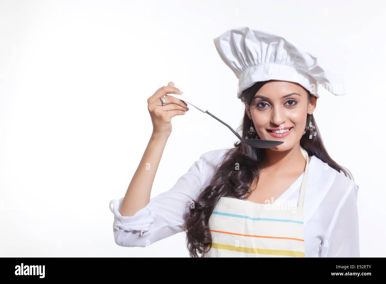 Portrait of a female chef tasting Stock Photo