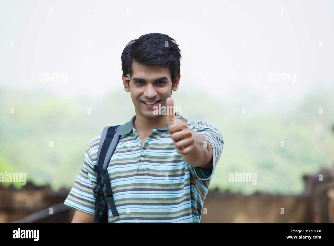 Portrait of a student giving a thumbs up Stock Photo - Alamy