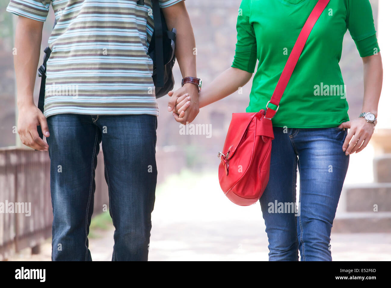 Couple holding hands in a park Stock Photo - Alamy