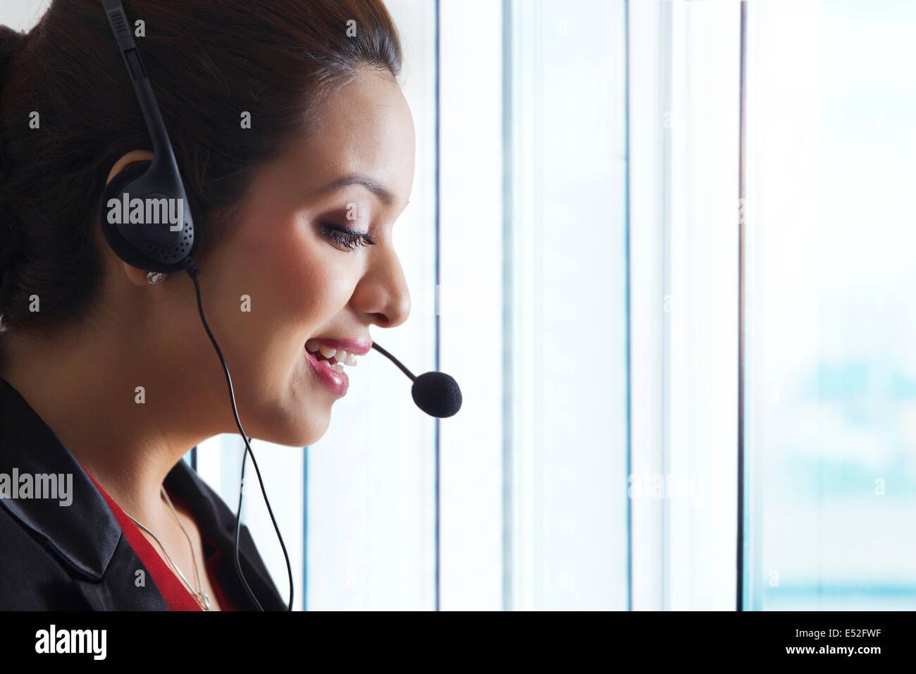 Side view of female customer service representative in office Stock Photo