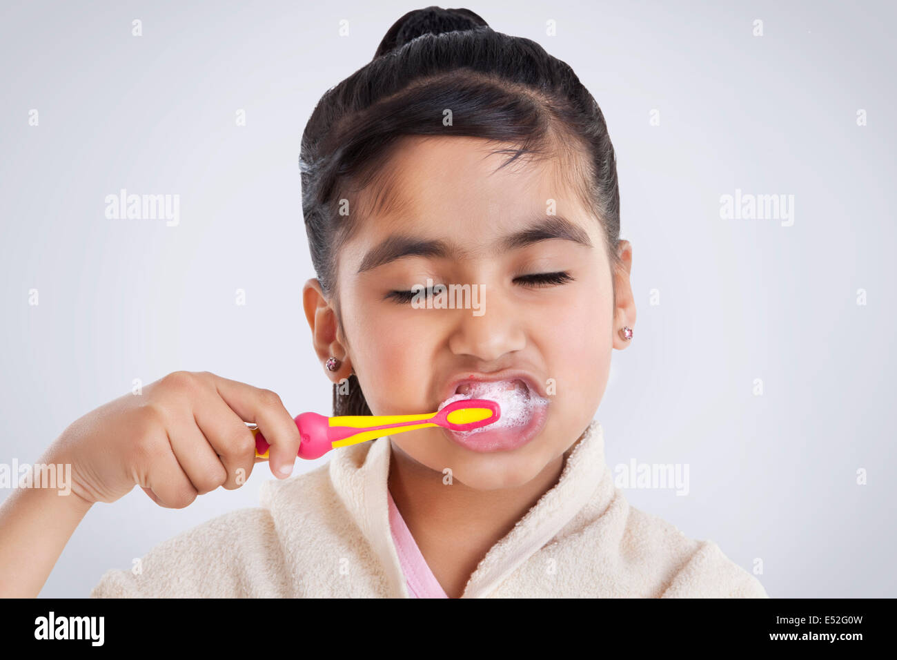 Little girl brushing her teeth Stock Photo