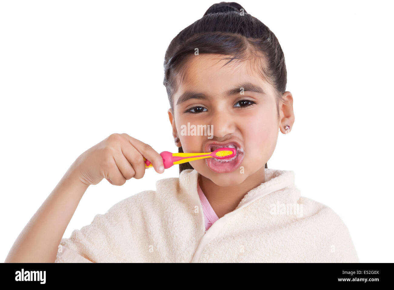 Portrait of little girl brushing her teeth Stock Photo