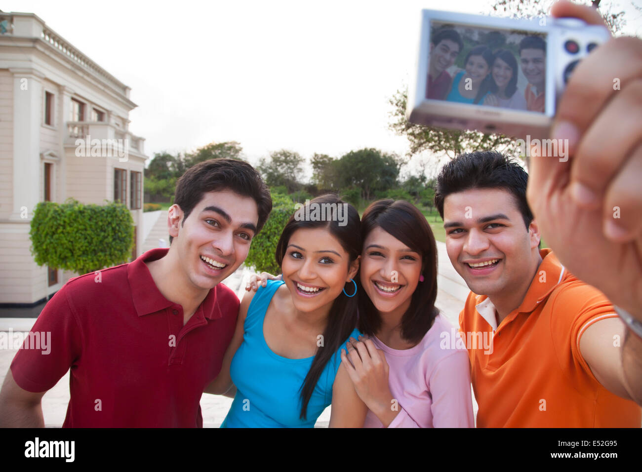 Cheerful friends taking selfie outdoors Stock Photo