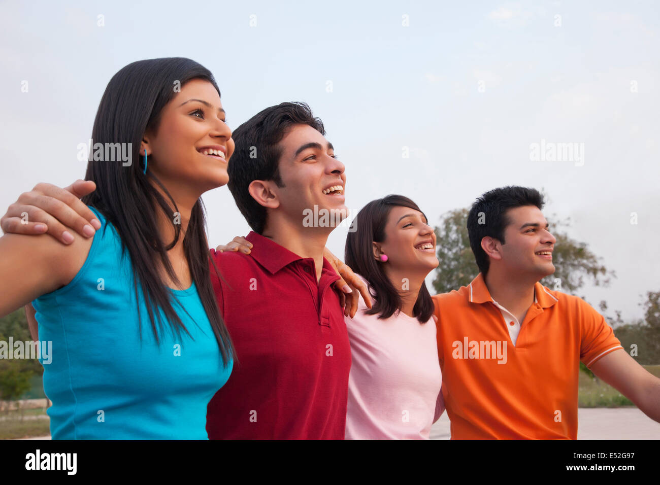 Cheerful friends looking away outdoors Stock Photo