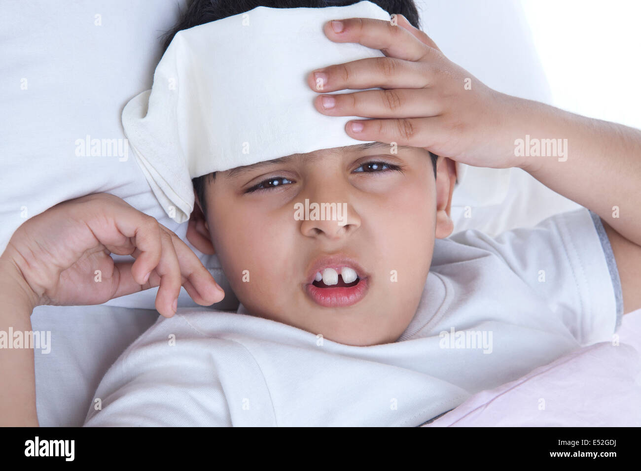 Portrait of little boy with wet cloth on forehead Stock Photo - Alamy