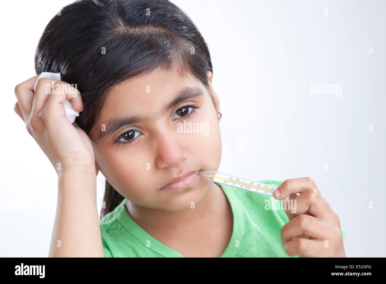 Little girl with thermometer in mouth Stock Photo