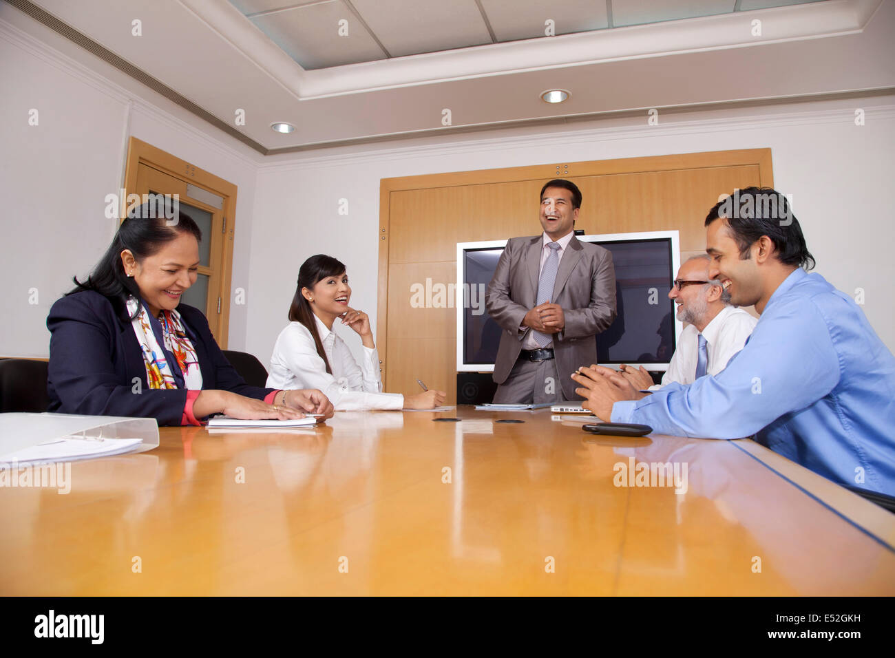 Business executives having a laugh during a meeting Stock Photo