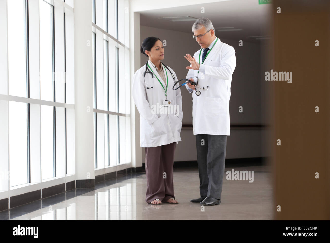 Two Doctors Talking In Corridor Of Hospital Stock Photo Alamy