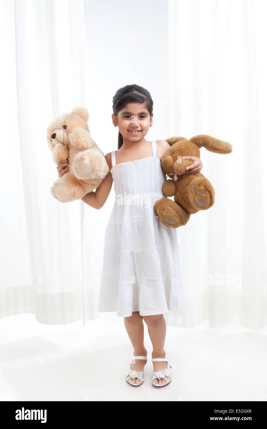 Portrait of a little girl with stuffed toys Stock Photo - Alamy