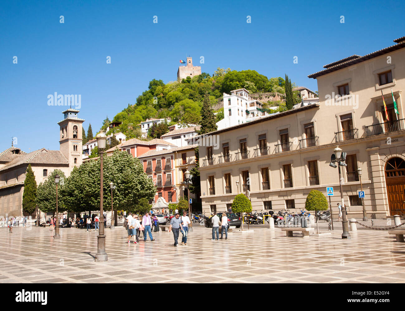 Historic buildings in Plaza Nueva, Granada, Spain looking up at part of the Alhambra on a hill top. Stock Photo