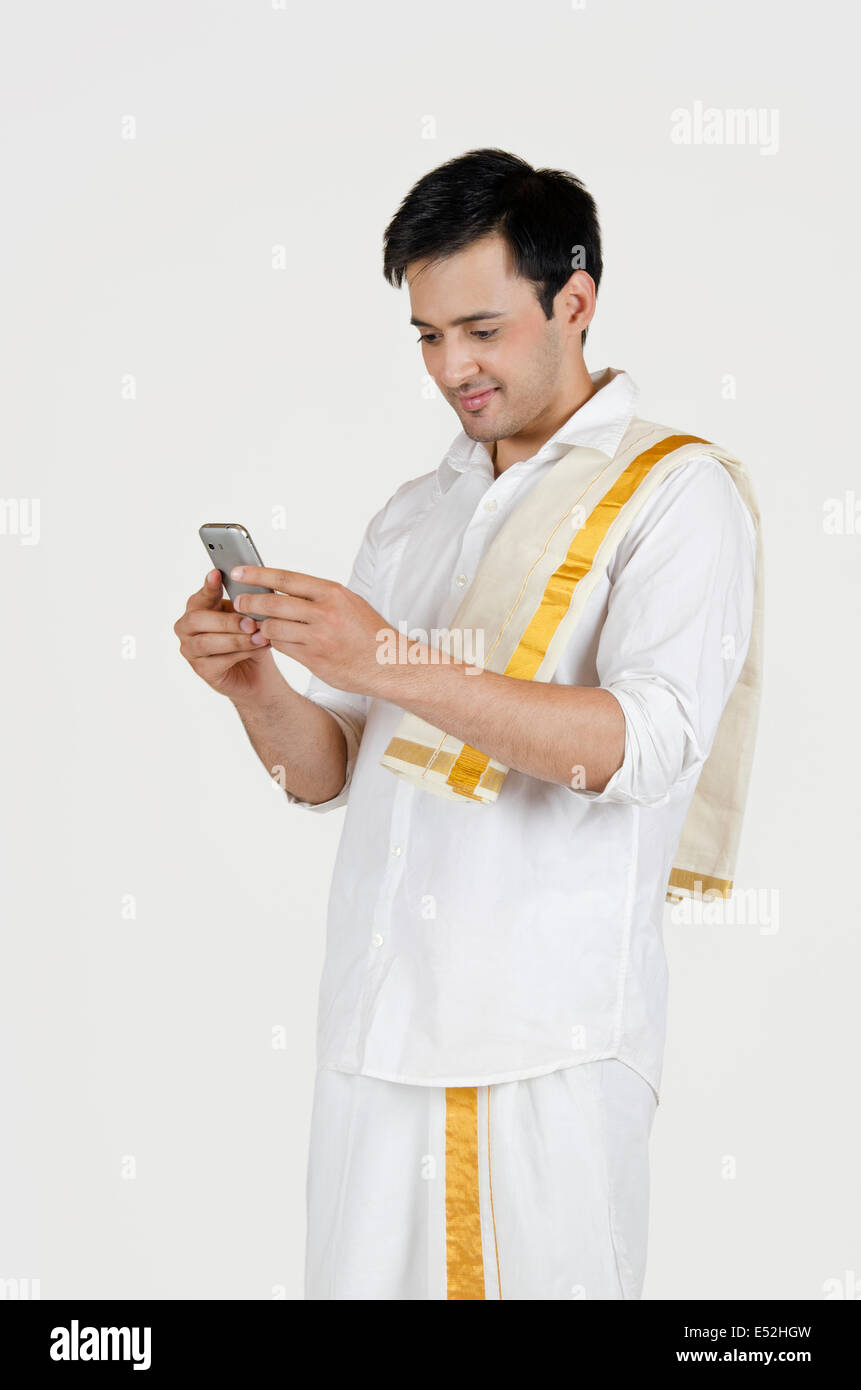 South Indian man reading an sms on a mobile phone Stock Photo