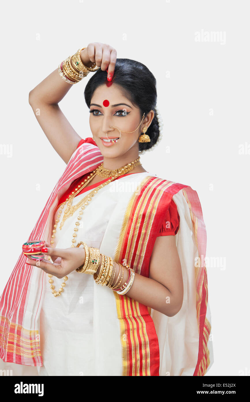 Bengali woman putting sindoor on hires stock photography and images