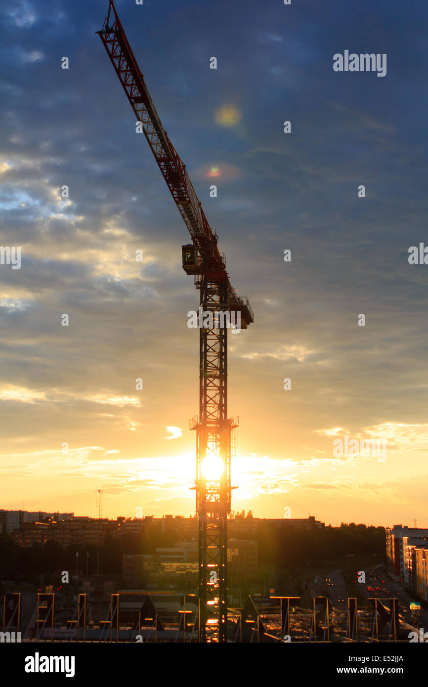 Construction crane in front of a blue sky with sunset Stock Photo - Alamy