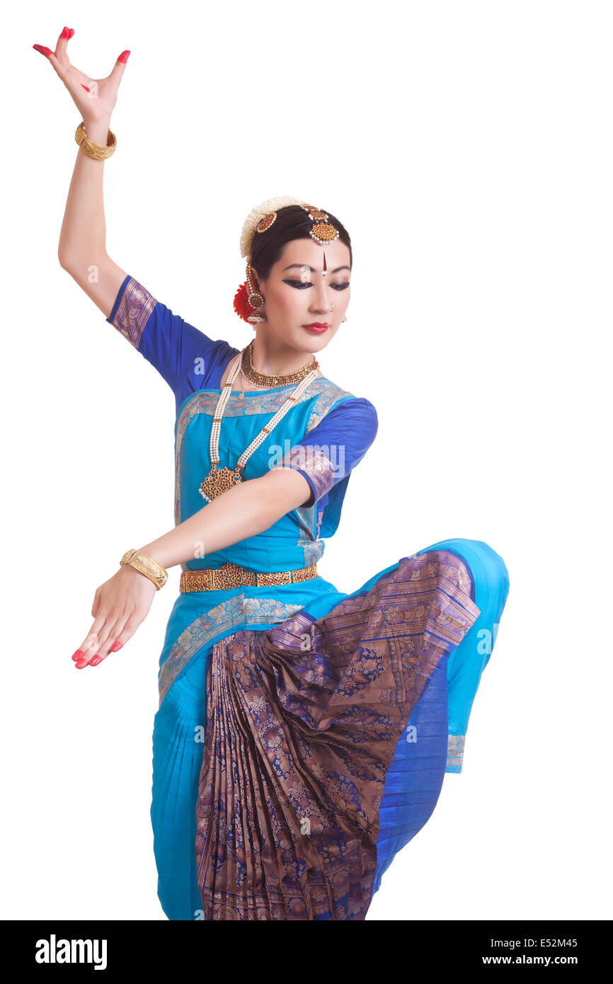 Dancer Posing While Performing Bharatanatyam Against White Background
