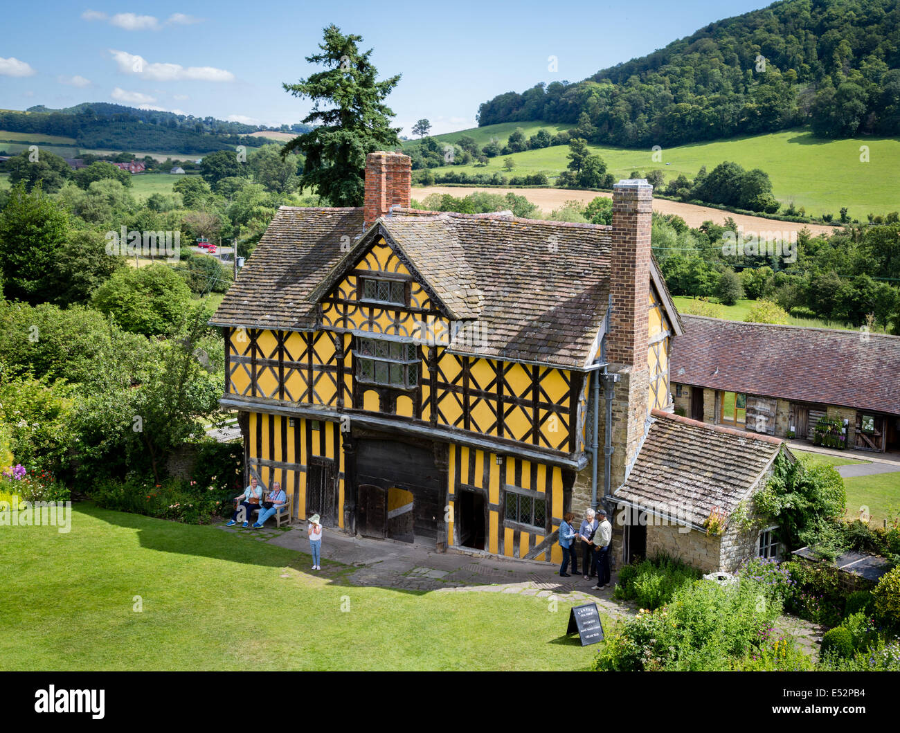 The timbered gatehouse of Stokesay Castle near Ludlow Shropshire UK and surrounding landscape of woods and fields Stock Photo