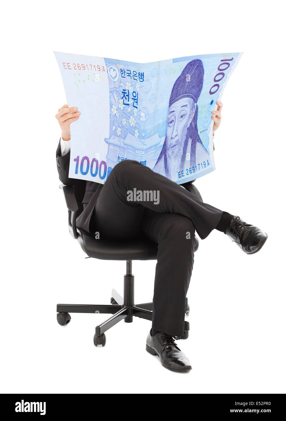 Business man sitting on a chair with korea currency in hands Stock Photo