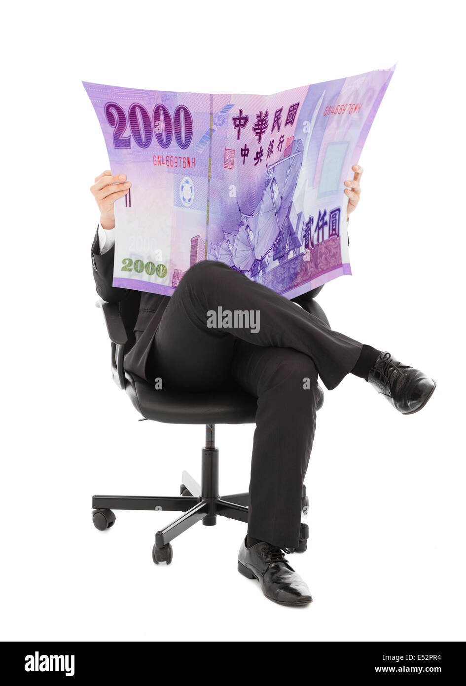 Business man sitting on a chair with taiwan currency in hands Stock Photo