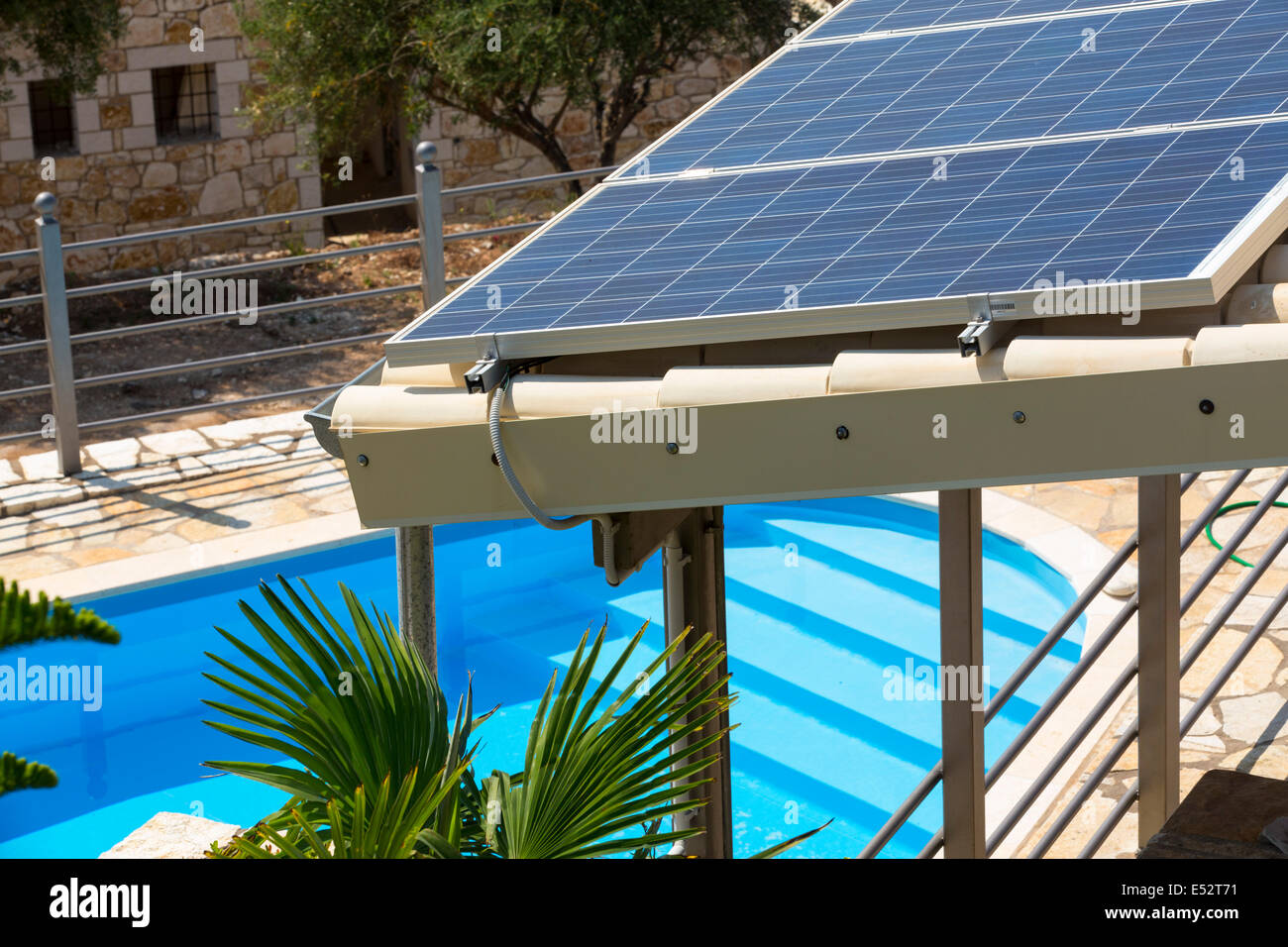 Solar panels on a roof in Sivota, Greece, with a swimming pool Stock