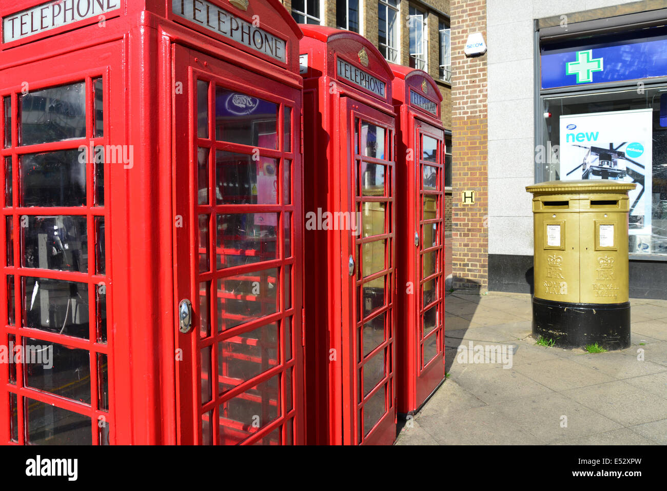 Red telephone boxes and gold pillar box, High Street, Uxbridge, London Borough of Hillington, Greater London, England, United Kingdom Stock Photo