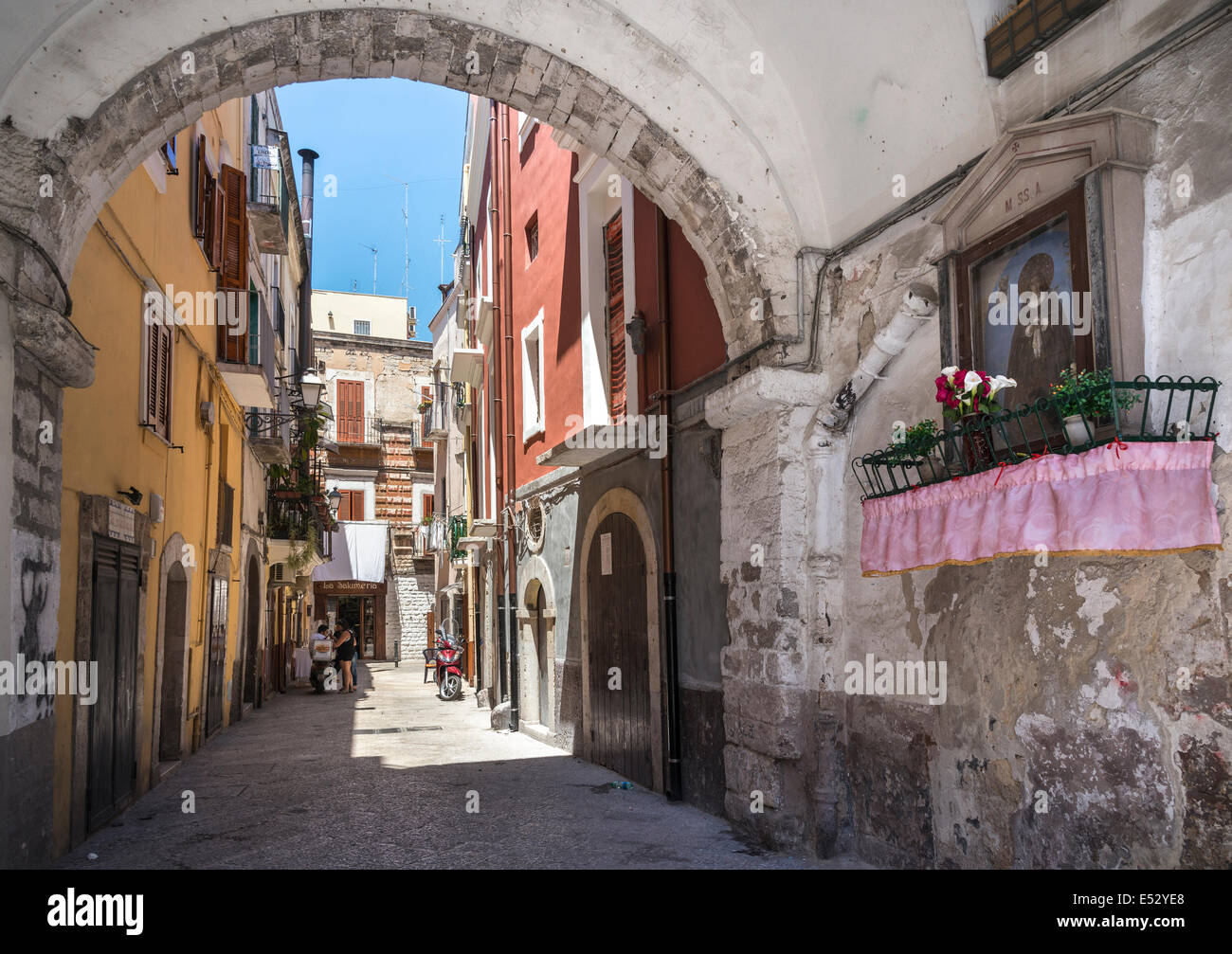 A typical street shrine and side alley in Barivecchia, Bari old town, Puglia, Southern Italy. Stock Photo