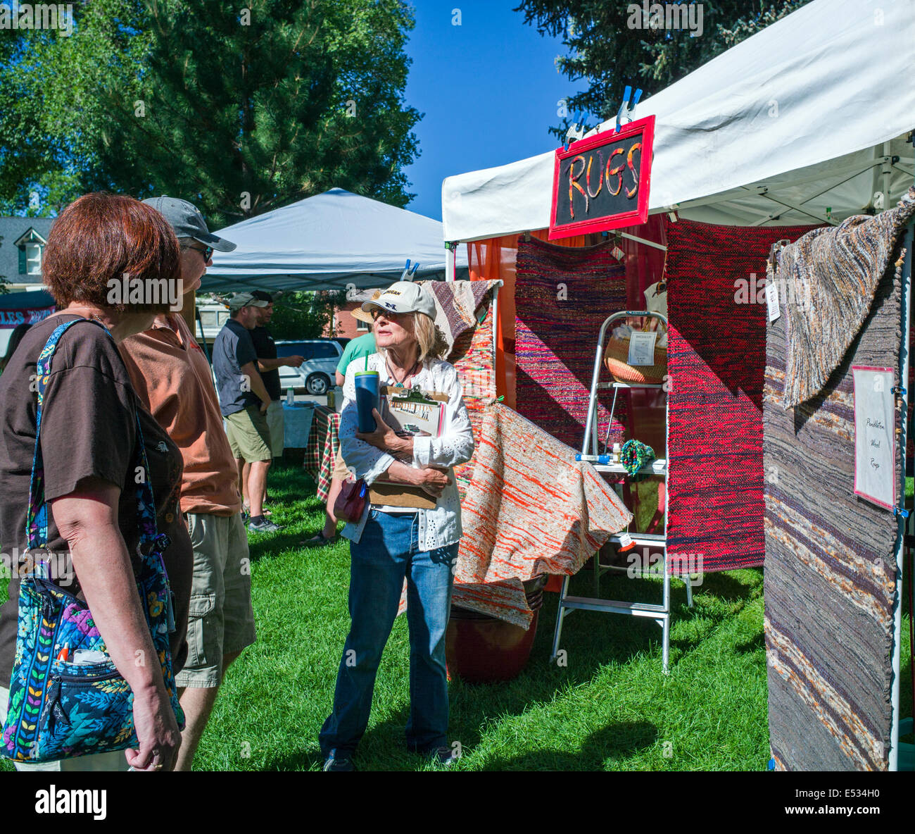 Vendors sell fresh vegetables, produce and other items at a seasonal farmers market in small mountain town of Salida, Colorado Stock Photo