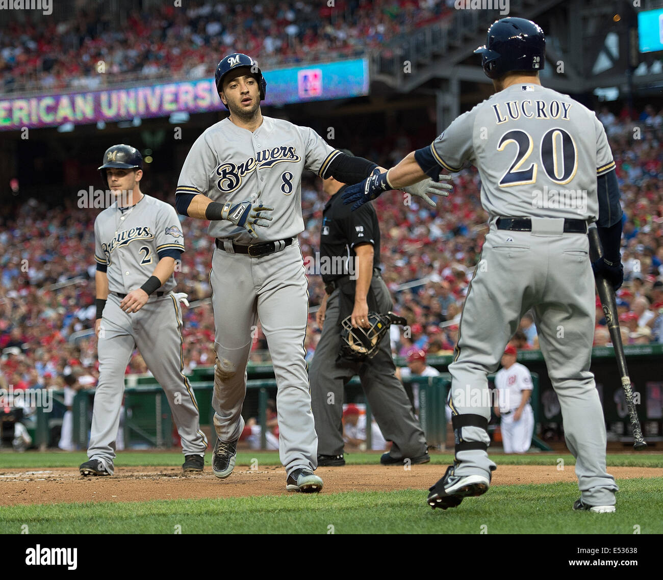 Milwaukee Brewers right fielder Ryan Braun (8) slaps hands with catcher Jonathan Lucroy (20) after he and  second baseman Scoote Stock Photo