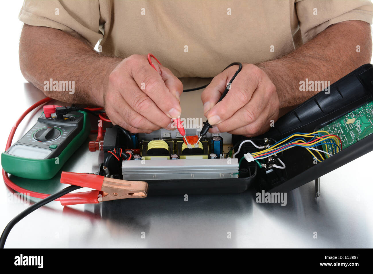 Closeup of the hands of a technician testing electrical equipment on