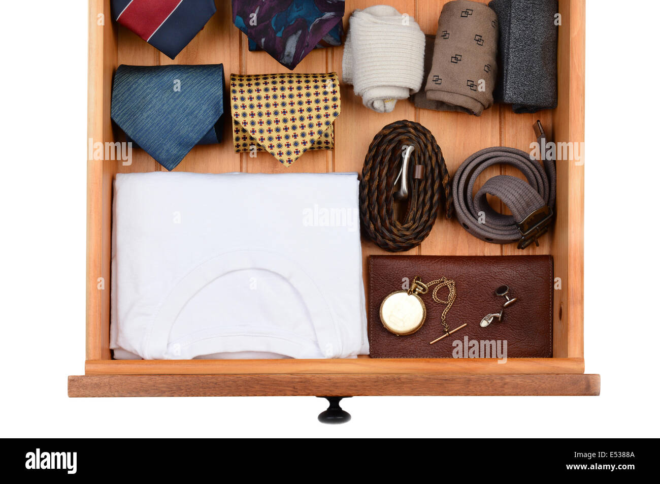 High angle shot of a dresser drawer with under shirts, belts, neck ties, socks, pocket watch and cuff links. Horizontal format i Stock Photo