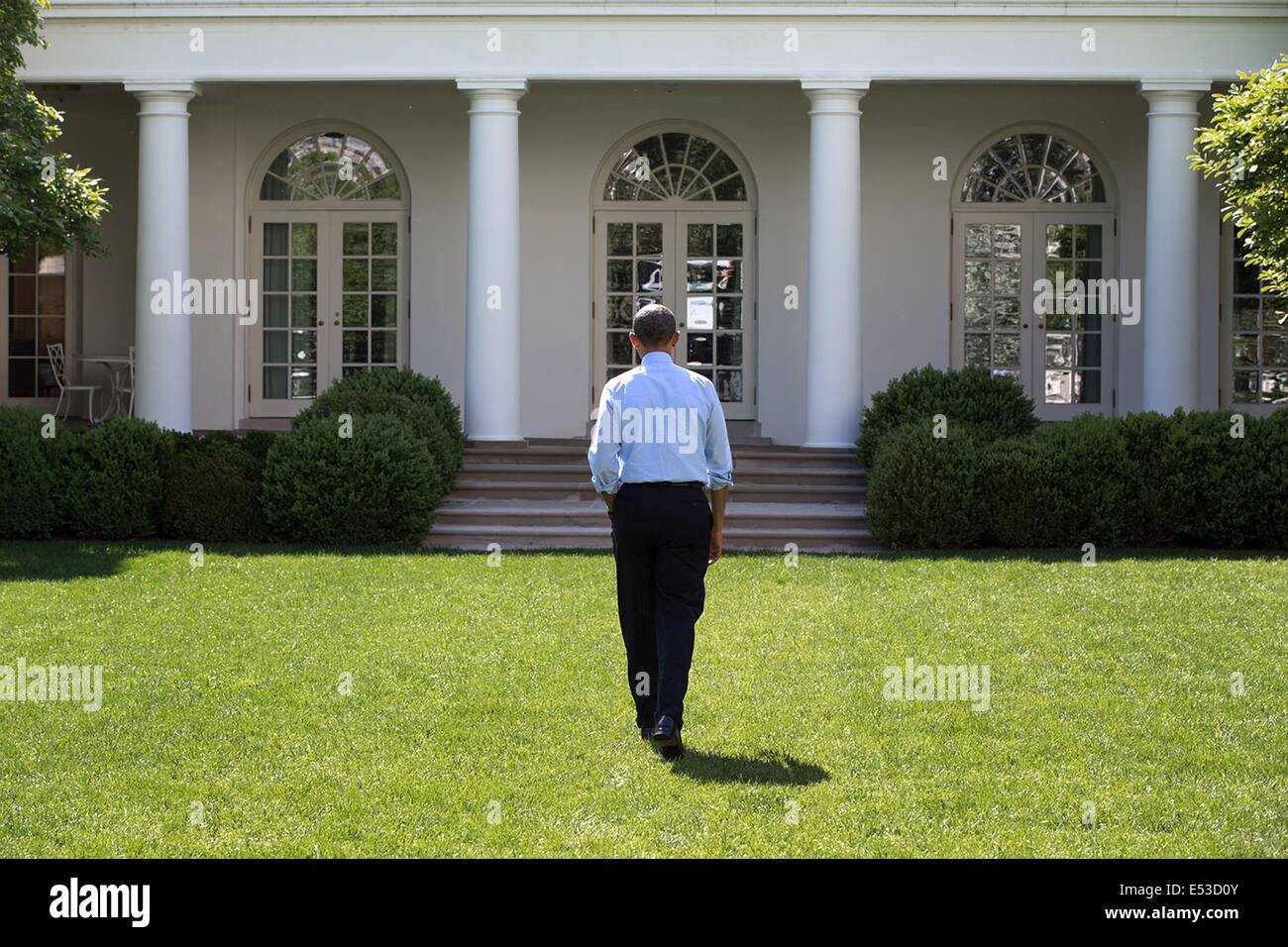 US President Barack Obama walks alone through the Rose Garden of the White House May 6, 2014 in Washington, DC. Stock Photo