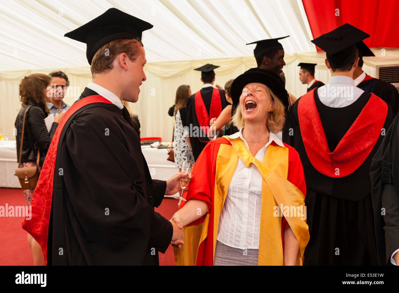 A Graduating Student (Daniel Rooney) From The University of Western England Shares A Joke With His Tutor At His Degree Ceremony Stock Photo