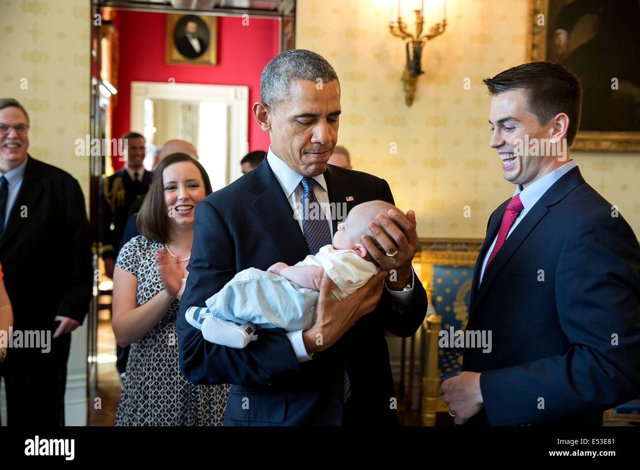 US President Barack Obama hold Silas McComb, son of  Sean McComb, National Teacher of the Year, and Sarah McComb, in the Blue Room of the White House prior to the Teacher of the Year event May 1, 2014 in Washington, DC. McComb teaches English at Patapsco High School & Center for the Arts in Baltimore, Maryland. Stock Photo