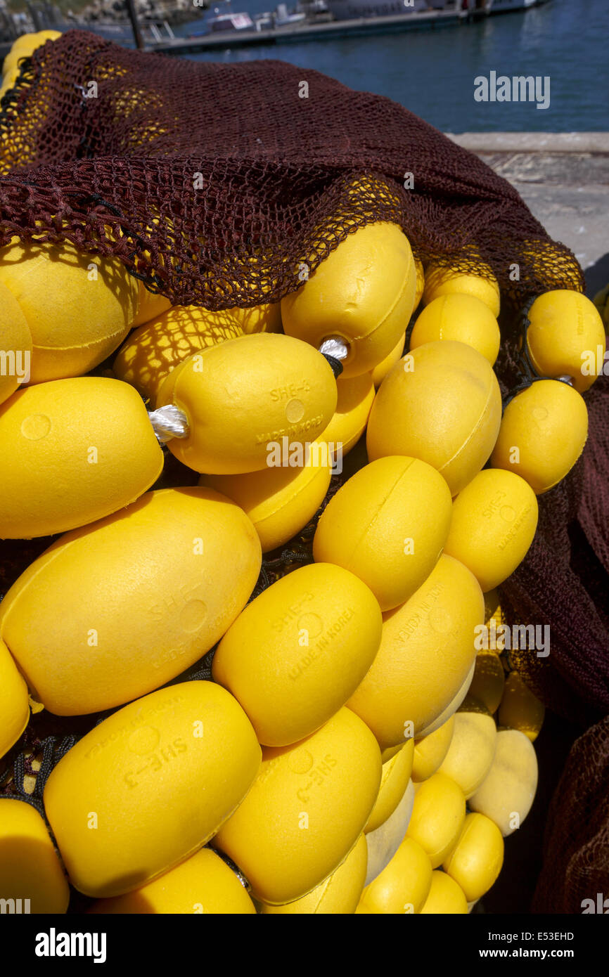 Yellow fishing net floats Stock Photo