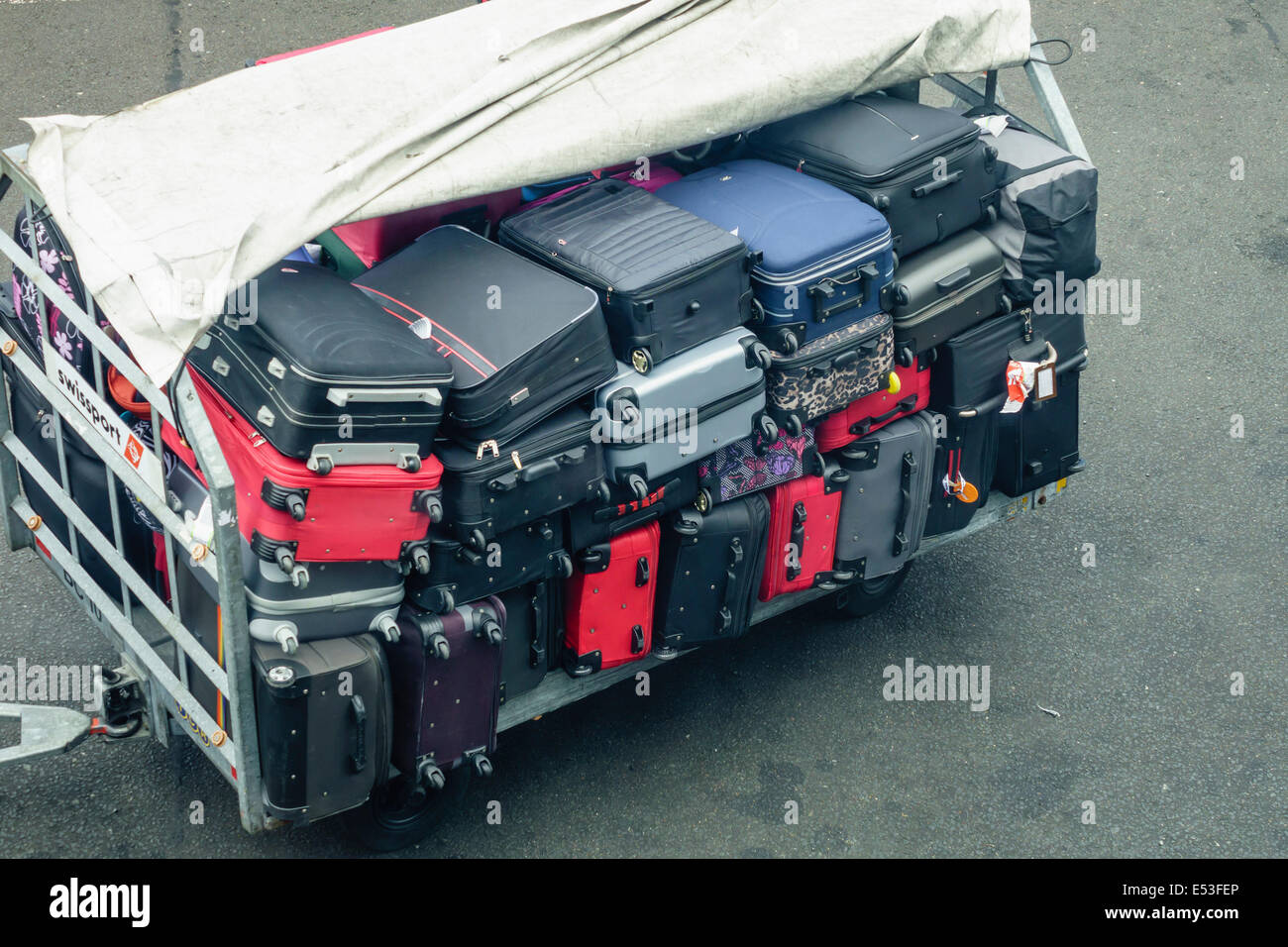 Suitcases on a baggage trolley waiting to be loaded into hold at