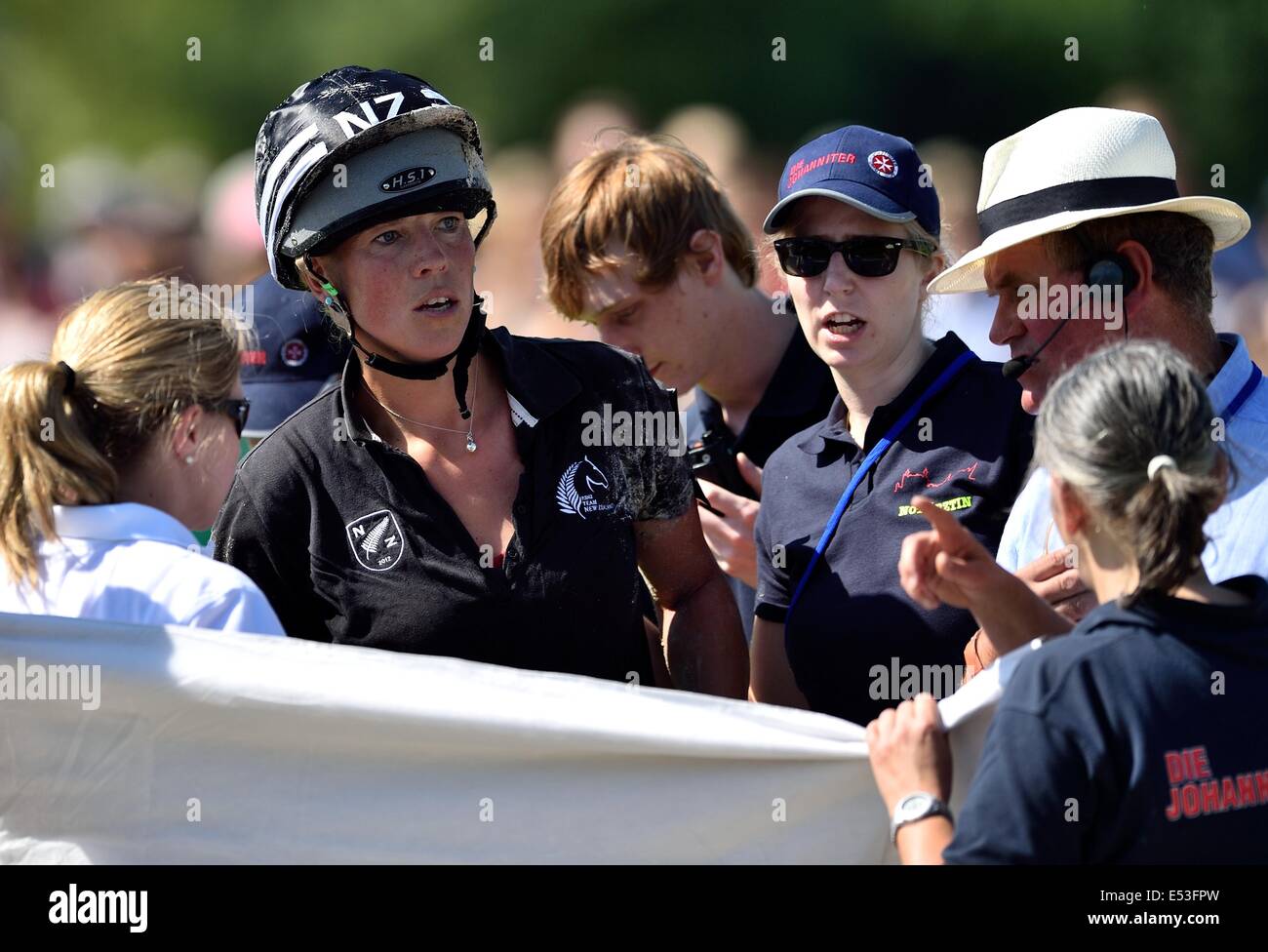 Aachen, Germany. 19th July, 2014. New Zealand rider Lucy Jackson (L) is surrounded by rescue and emergency< staff after her fall during the cross-country discipline of the eventing event of the CHIO in Aachen, Germany, 19 July 2014. Photo: UWE ANSPACH/DPA/Alamy Live News Stock Photo