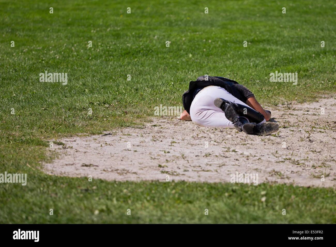 Aachen, Germany. 19th July, 2014. New Zealand rider Lucy Jackson lies on the ground after her fall during the cross-country discipline of the eventing event of the CHIO in Aachen, Germany, 19 July 2014. Photo: ROLF VENNENBERND/DPA/Alamy Live News Stock Photo