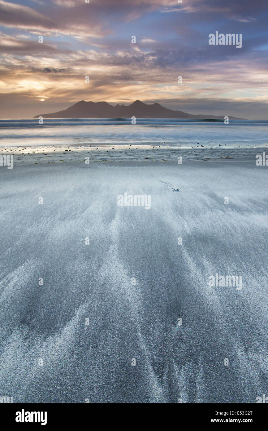 Sunset over The Isle of Rum seen from Laig Bay sands, Isle of eigg, Small Isles, Inner Hebrides, Scotland, UK Stock Photo