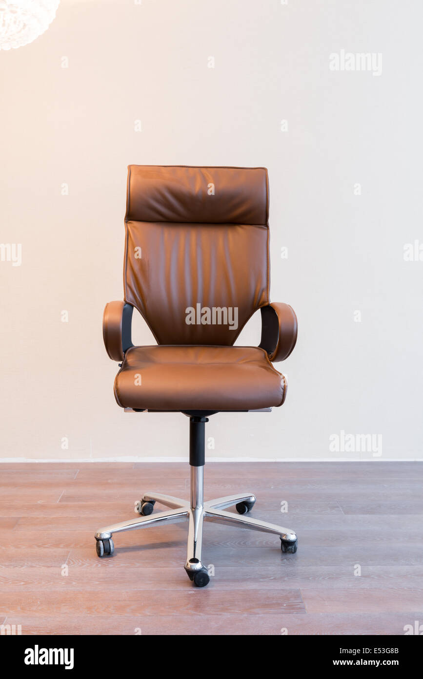 Comfortable office chair with leather upholstery and shiny legs Stock