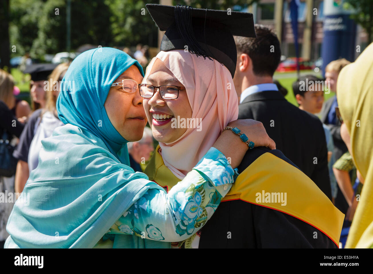 Female international student is congratulated at a university graduation, Keele University, UK Stock Photo